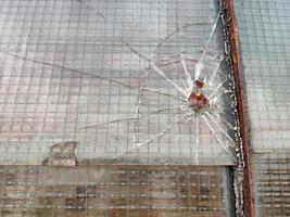 gun bullet broken window glass photo