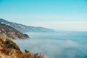 Clouds over the ocean with cliffs photo