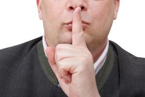 male finger near lips - silence hand gesture photo