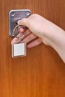 opening home door by key with blank keychain photo