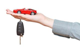 new red car with key on hand isolated photo