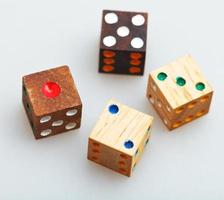 four wooden gambling dices on white table photo