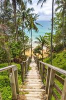 Wood stairs steps down to Naithon Beach turquoise water Thailand. photo