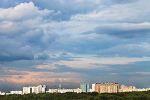 blue clouds in pink sky over town photo