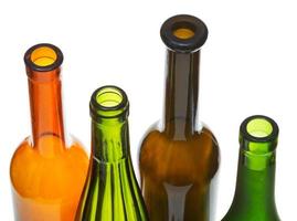 open bottlenecks of colored wine bottles close up photo