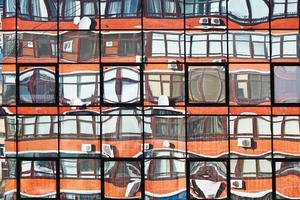 reflejo de la casa de apartamentos en las ventanas de los espejos foto