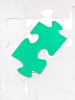 green piece on free space of assembled puzzles photo