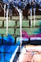 icicles on roof of building with painted wall photo