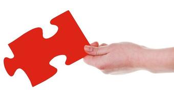 female hand with red puzzle piece photo