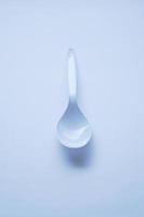 White disposable plastic spoon used for eating photo