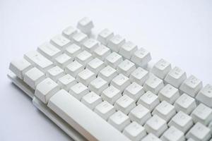 Used white computer keyboard that is not used until it gets dusty photo