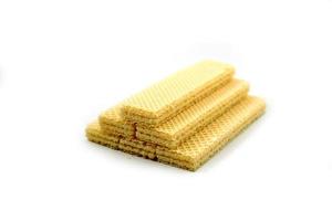 Delicious wafer sticks arranged in a pyramid shape isolated on a white photo