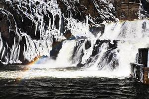 rainbow on river waterfall photo