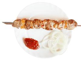 top view of skewer with lamb shish kebab isolated photo