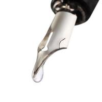 liquid drop dripping from the nib of pen photo