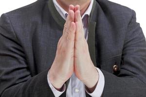 front view of businessman praying hands photo