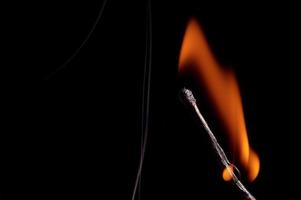 Burning matchstick and fire photo