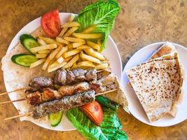 portion of various arabian kebabs on plate photo