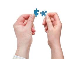 male and female hands with little puzzle pieces photo