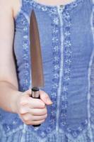 woman holding large kitchen knife photo