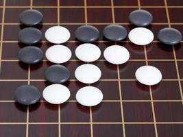 many black and white stones during go game playing photo