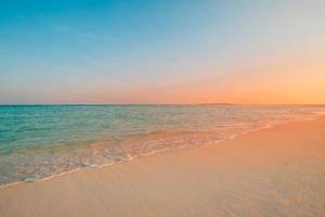 Closeup sea sand beach. Panoramic beach landscape. Inspire tropical beach seascape horizon. Orange and golden sunset sky calmness tranquil relaxing sunlight summer mood. Vacation travel holiday banner photo