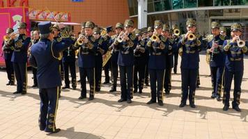 ASTANA, KAZAKHSTAN, MAY 8, 2016 - Emotional conductor of brass band, Philharmonic Orchestra concert outdoor near city mall video