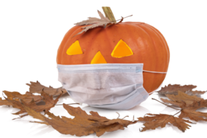 An orange festive pumpkin with glowing eyes, wearing a disposable medical mask. Halloween concept. transparent background. PNG