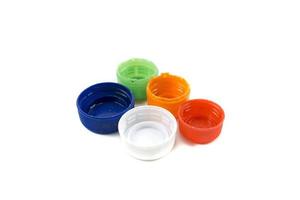 Colorful plastic bottle caps including recyclable materials isolated on a white photo