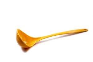 yellow ladle used to scoop soup isolated on a white photo