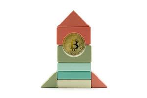 Bitcoin rate growth concept. Bitcoin rocket wooden toy flying to the moon photo