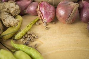 The scattered kitchen spices contained shallots, coriander, bay leaves. photo