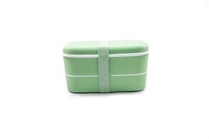 green plastic lunch box isolated on white background photo