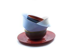 stack of empty plates and bowls isolated on a white photo