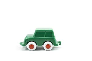 Green paint plastic toy terrain car isolated on white photo