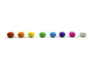 gradient colorful milk chocolate candy shell isolated on a white background. photo