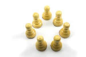 A group of chess pawns make groups to discuss strategies in a circle photo