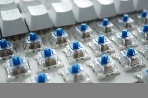 narrow depth of blue switch with disassembled mechanical keyboard game. photo