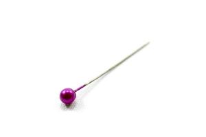 pink sewing straight pin isolated on white background. photo