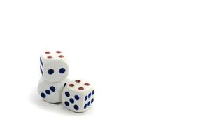 Three plastic dice isolated on a white background, a dice is a small object photo