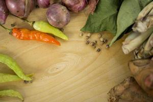 The scattered kitchen spices contained shallots, coriander, bay leaves. photo