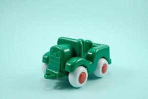 Army car open roof green paint plastic toy isolated on turquoise photo