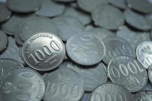 macro a thousand rupiah coins, macro coins, piles of coins on the table photo