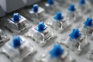 narrow depth of blue switch with disassembled mechanical keyboard game. photo