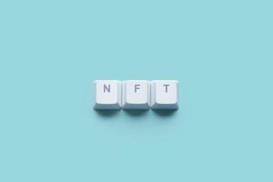 Word Non-Fungible Token NFT written on computer keyboard keys photo