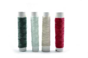 Rows of sewing threads of various colors photo