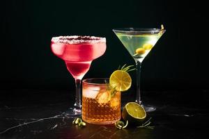 Alcoholic and non-alcoholic cocktails on a dark marble table. Summer refreshments photo