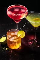 Alcoholic and non-alcoholic cocktails on a dark marble table. Summer refreshments photo