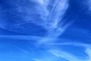 Stunning cirrus cloud formation panorama in a deep blue sky photo