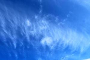 Stunning cirrus cloud formation panorama in a deep blue sky photo